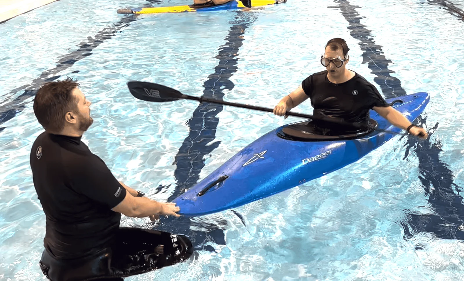Kayak rolling coaching in a swimming pool